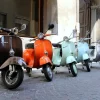 Classic italian scooters parked in ancient street old town at Treviglio Vintage festival. Piaggio Vespa Italy vintage scooters.